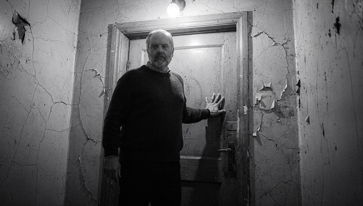 Man preparing physical expression before high-stakes meeting door