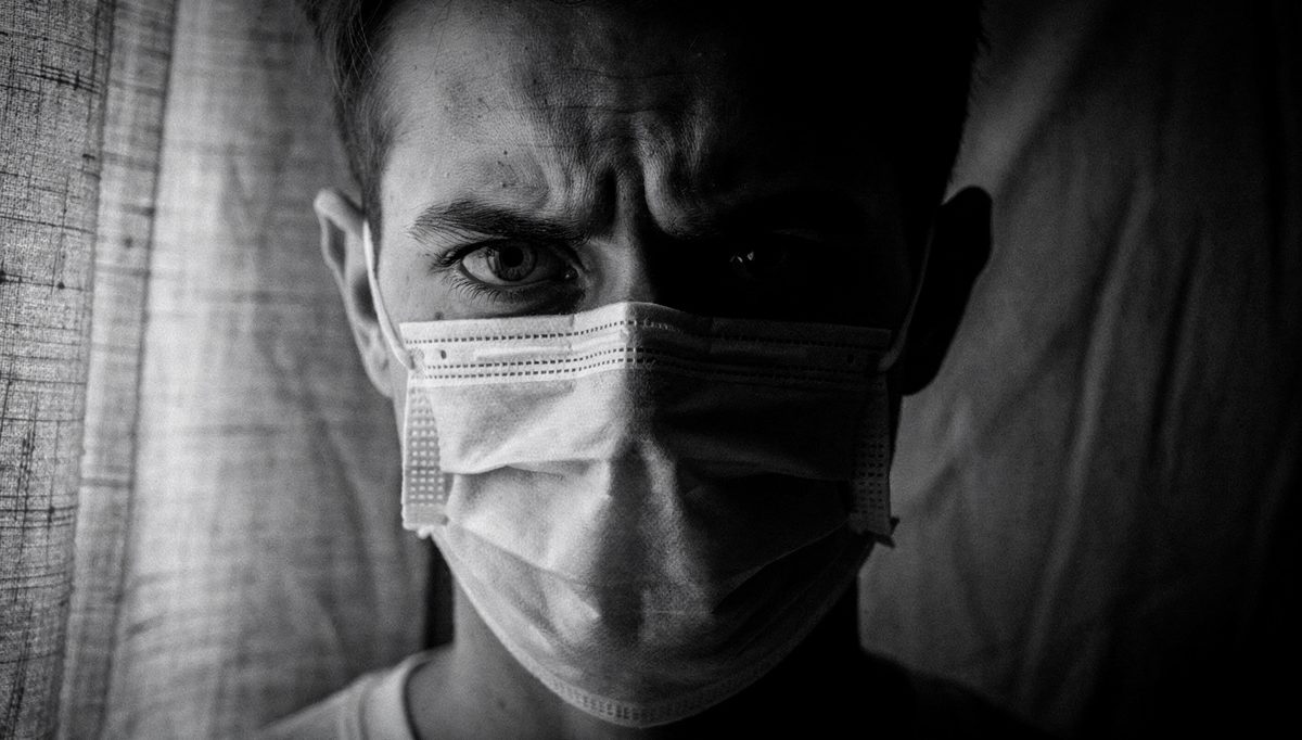 Close-up portrait showing eye contact demands with face mask